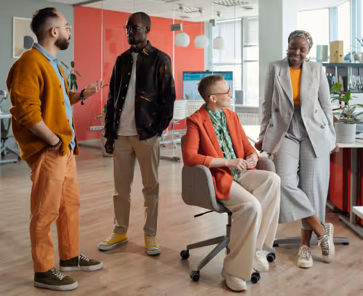 Marketers talking and working together in a bright colorful modern office setting