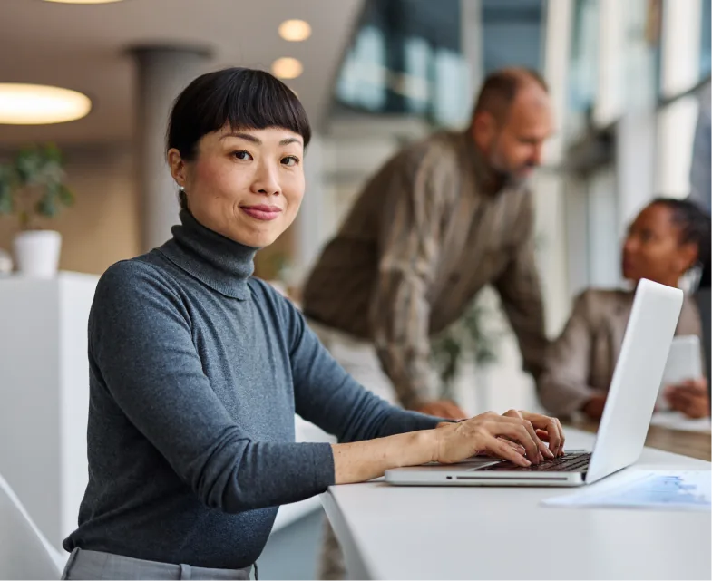 A woman using a laptop in an office space