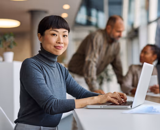 A woman using a laptop in an office space