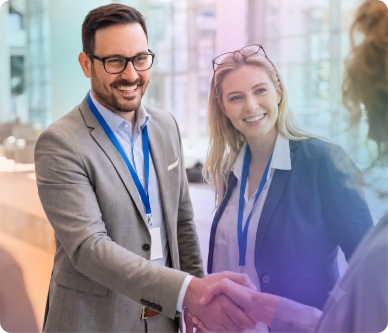 Business professionals at a concert greeting one another with a handshake