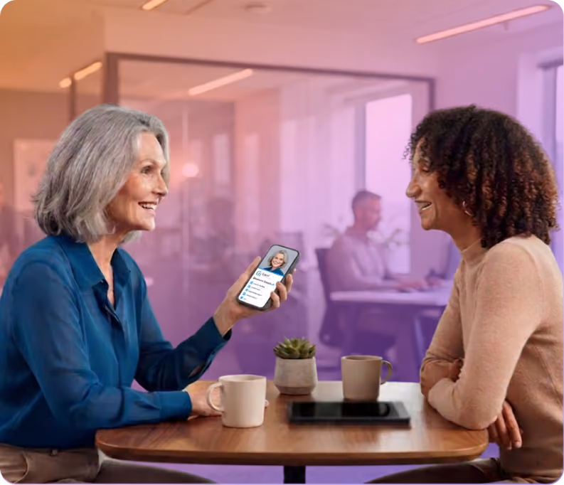 Business professionals in conversation in a colorful, modern office using HiHello digital business cards