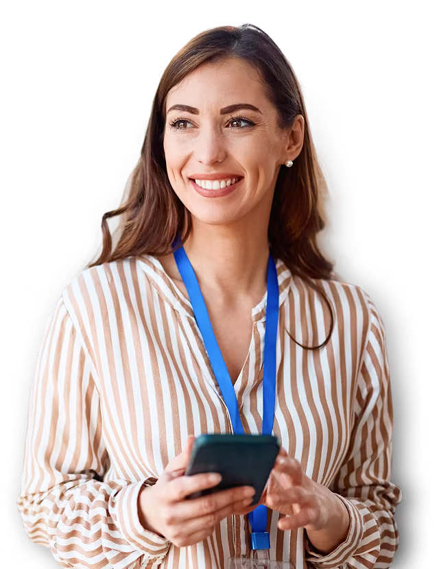 A woman holding a cell phone with an event badge