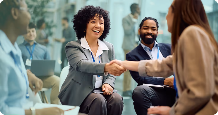 Professionals shaking hands in a event setting