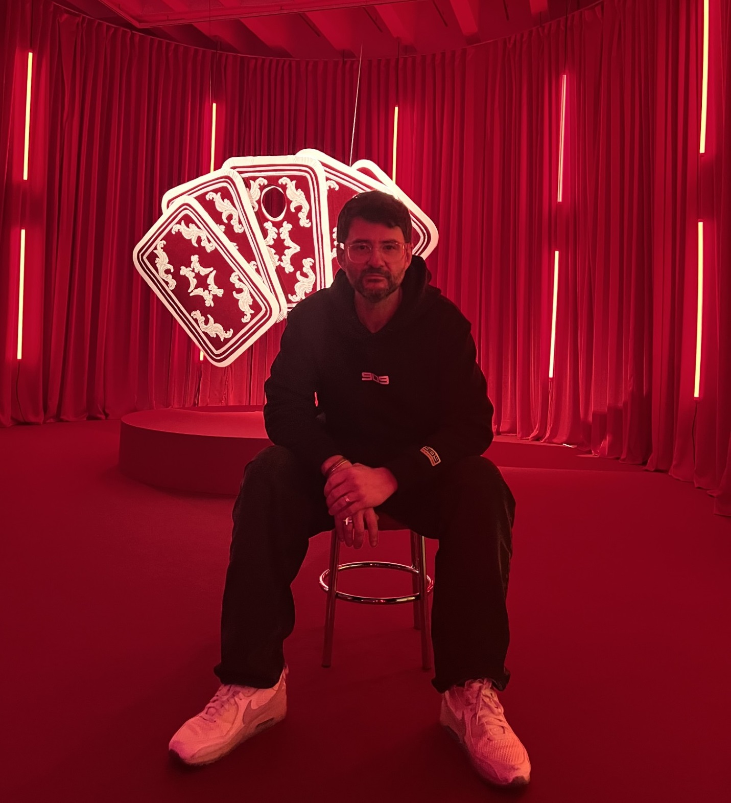 The photo shows a man covering his face with his hand