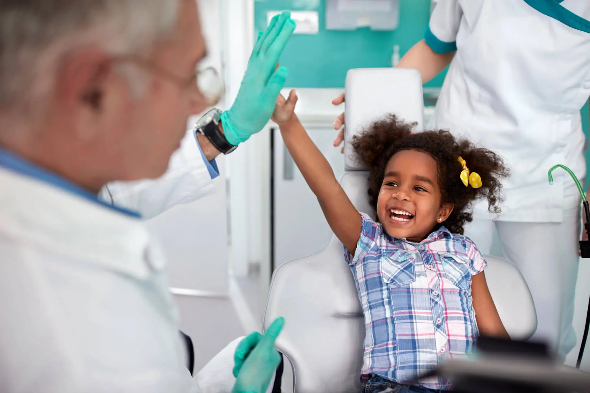 little girl visiting her pediatric dentist