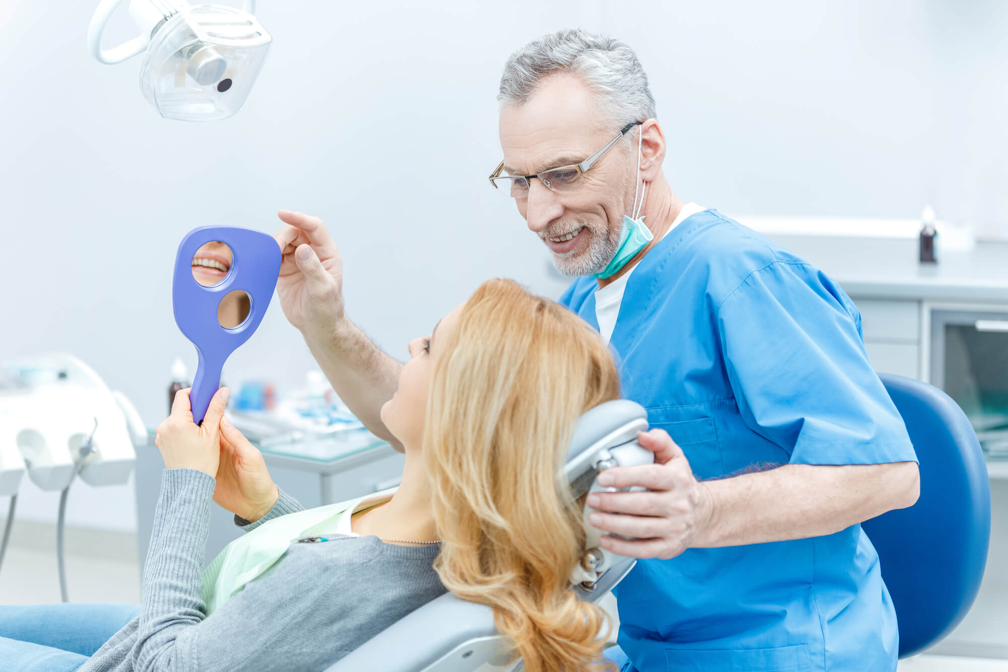 Dentist in Dania Beach showing patient her teeth