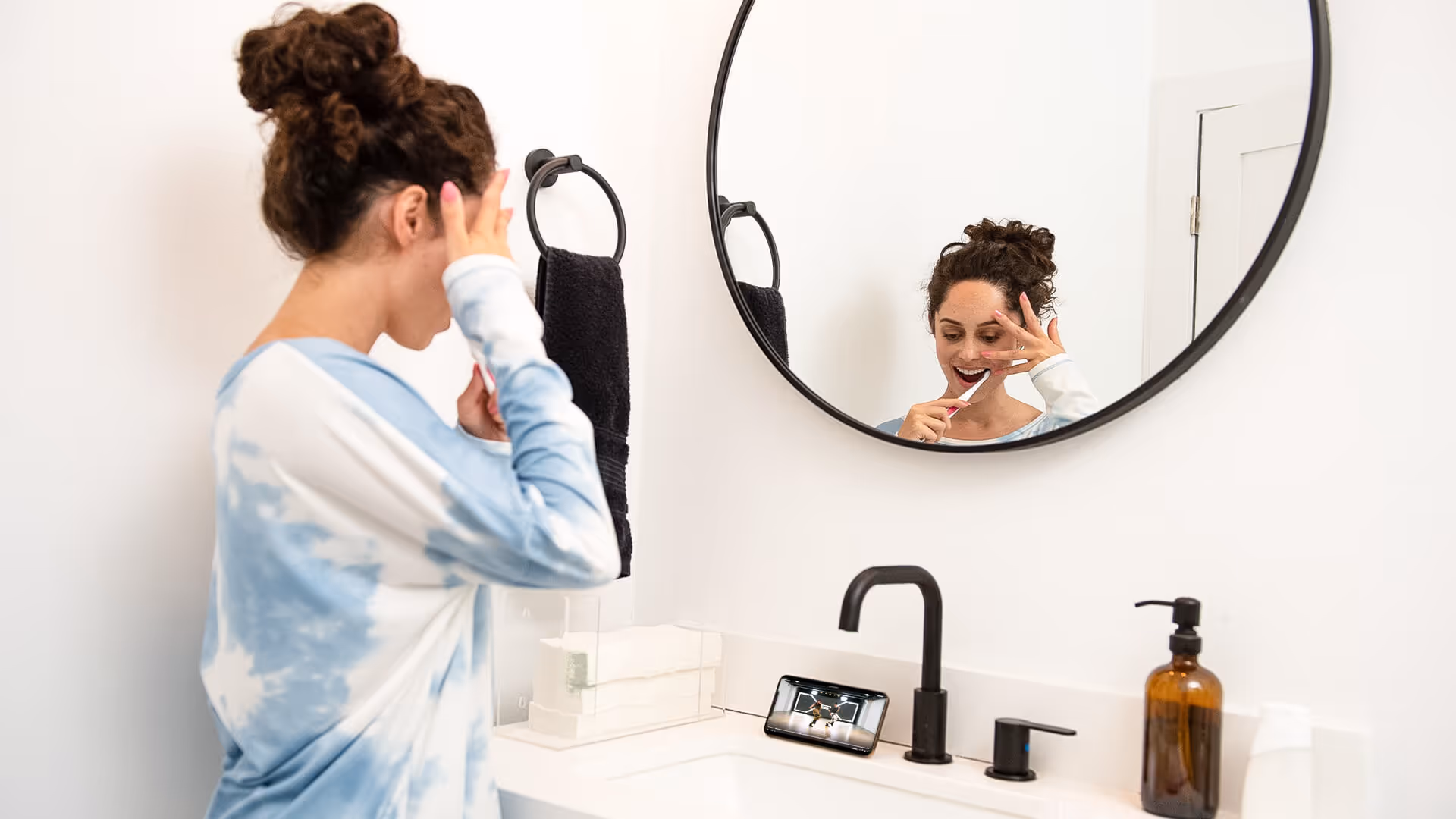 Girl taking dance class while getting ready