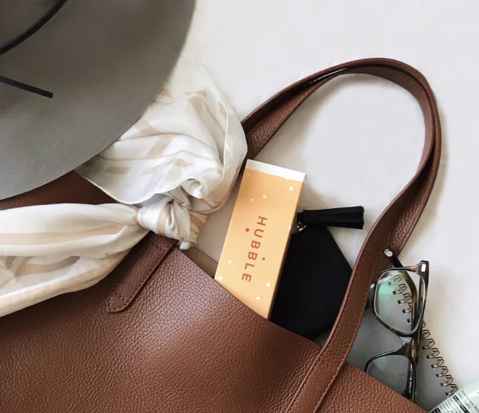 A brown purse with a tag that says Hubble.