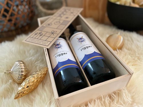 Two wine bottles with customized labels and a personalized greeting card