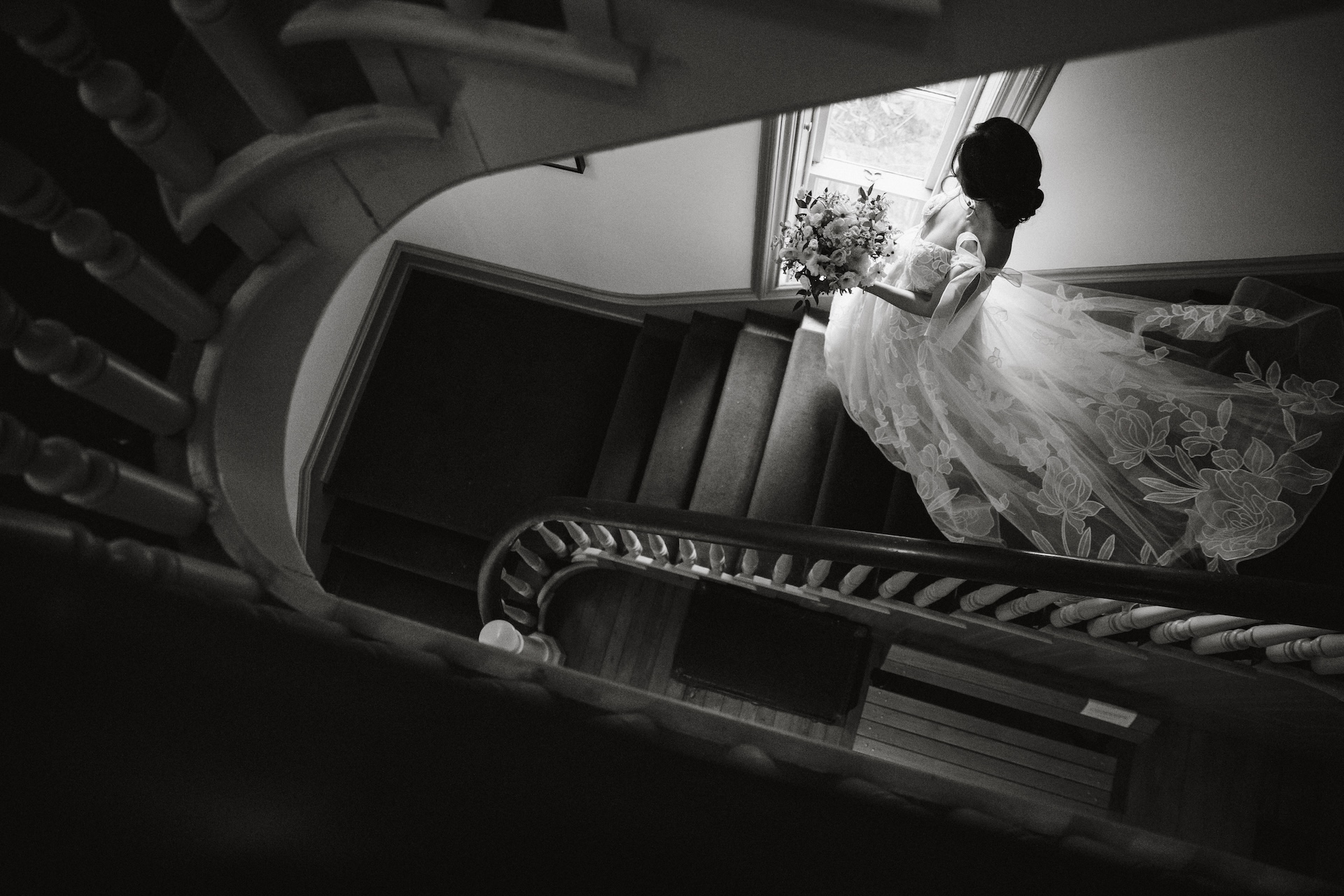 Overhead shot of a bride walking down the stairs of the Cope House 