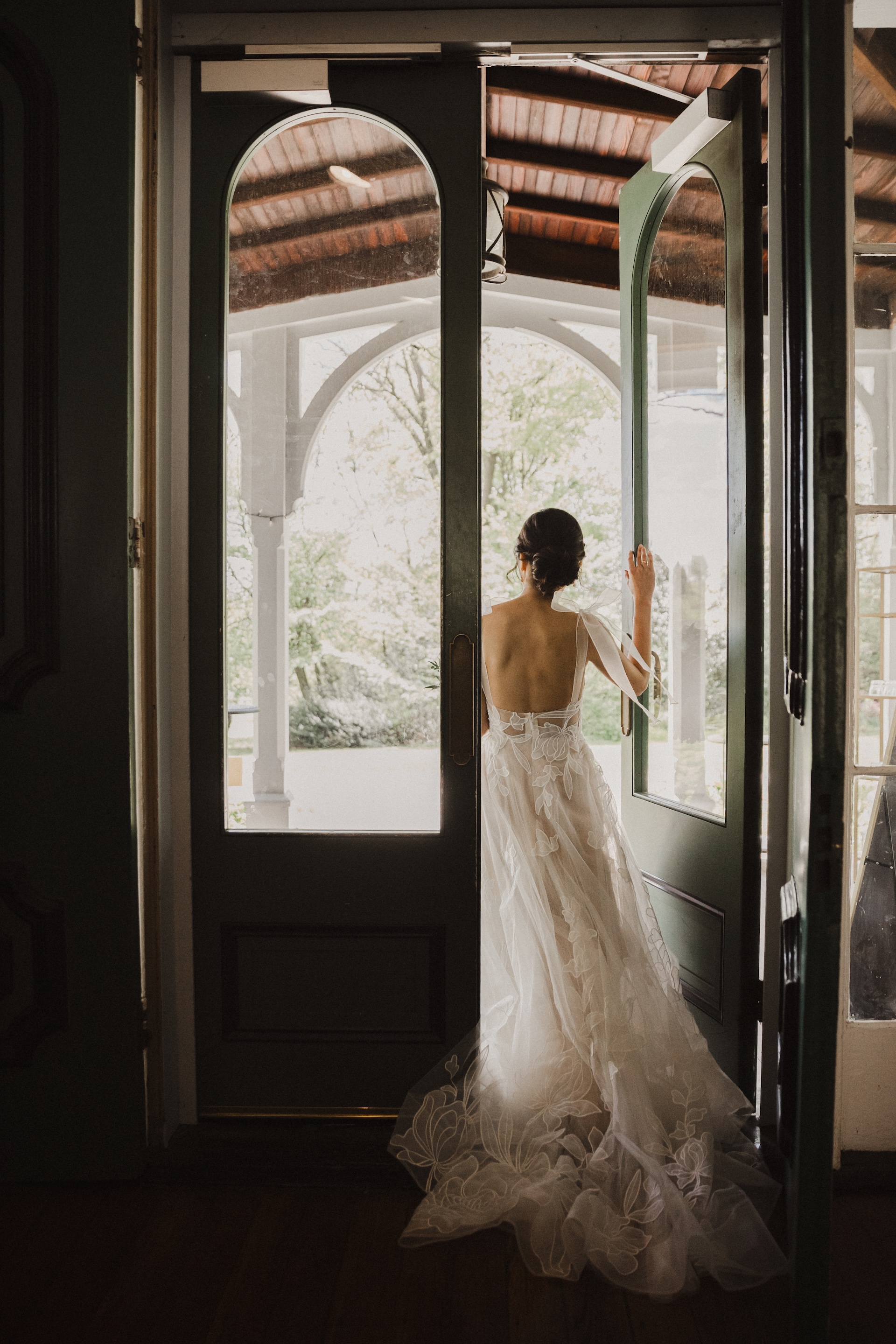 Gorgeous photo of bride walking out front door of Cope House onto the porch