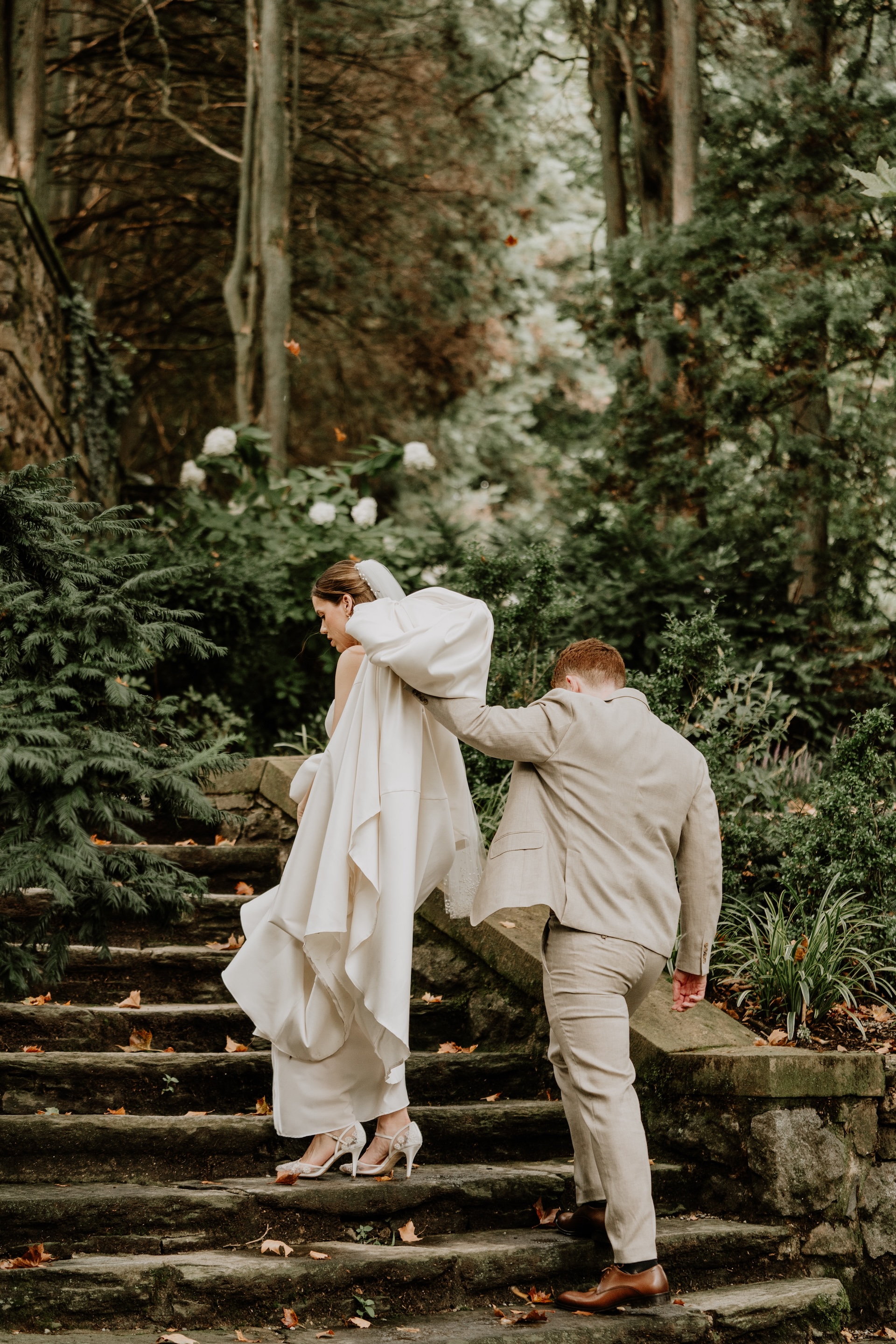Couple walking the grounds at Parque, up the stone steps