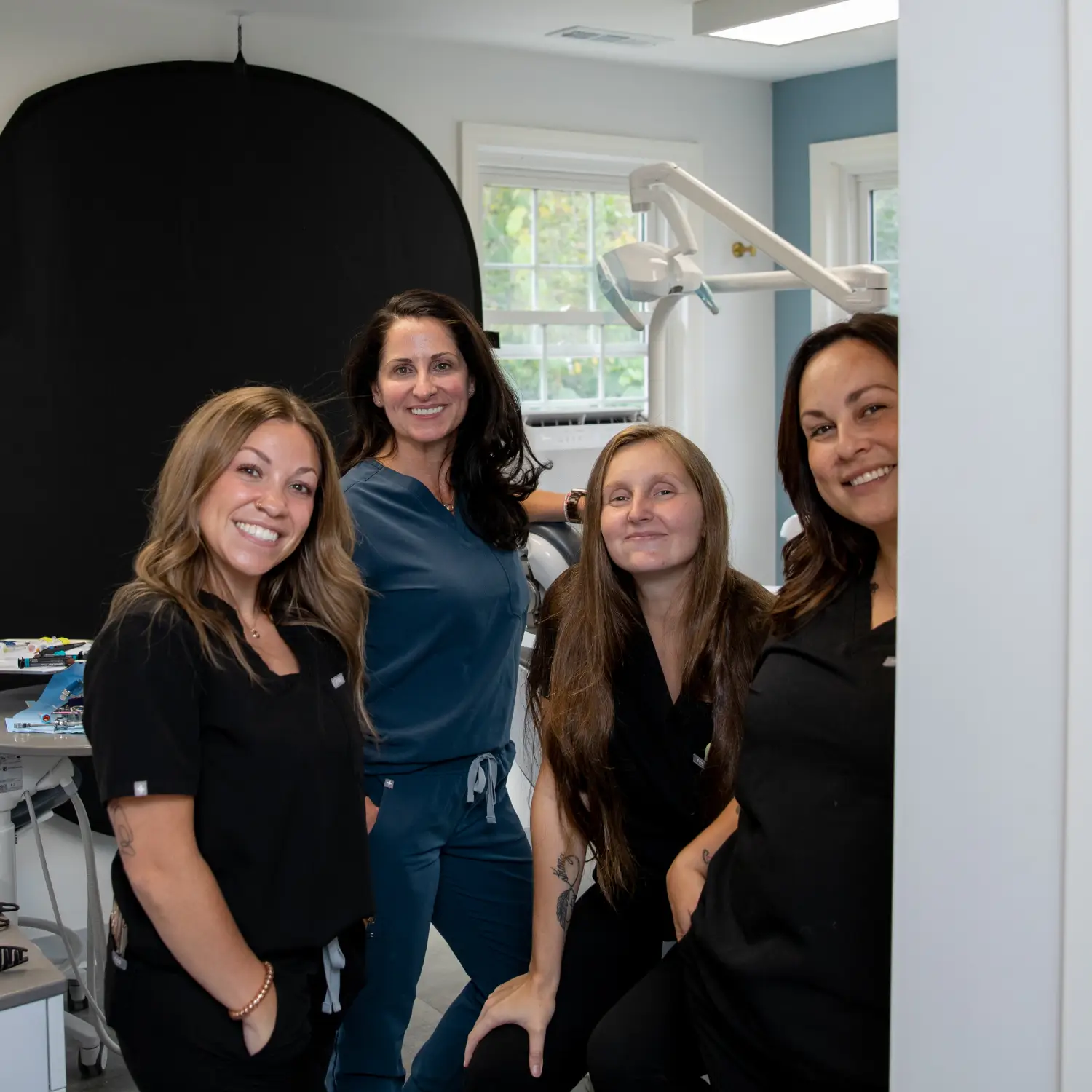 patient smiling and holding up invisalign 