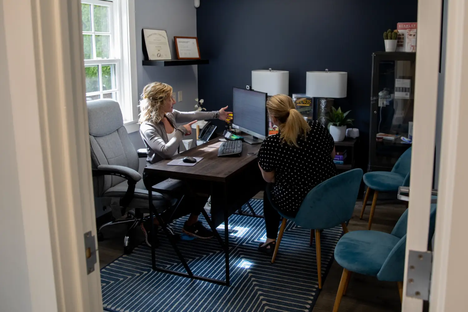 patient smiling and holding up invisalign
