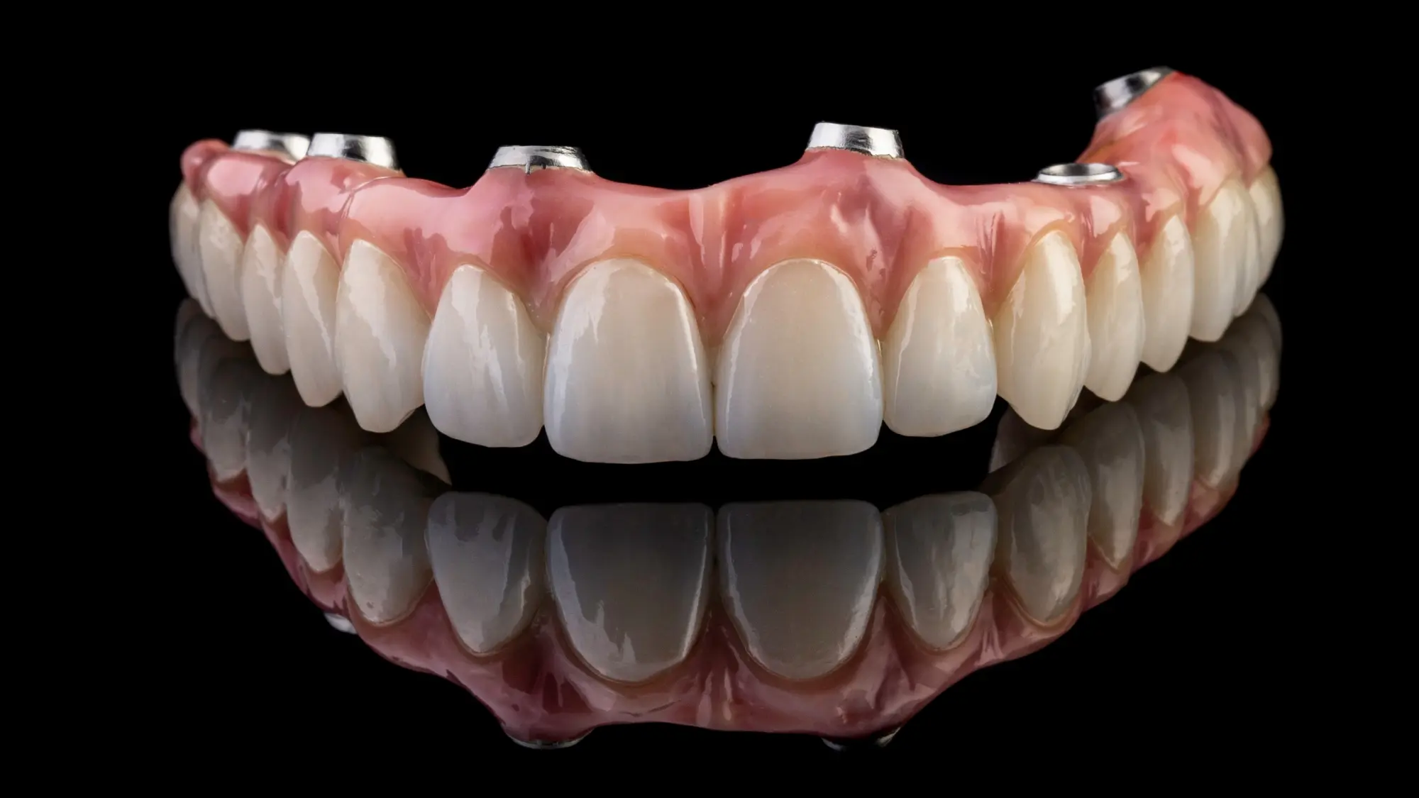 patient smiling and holding up invisalign 