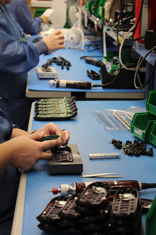 Assembling devices on an assembly line.