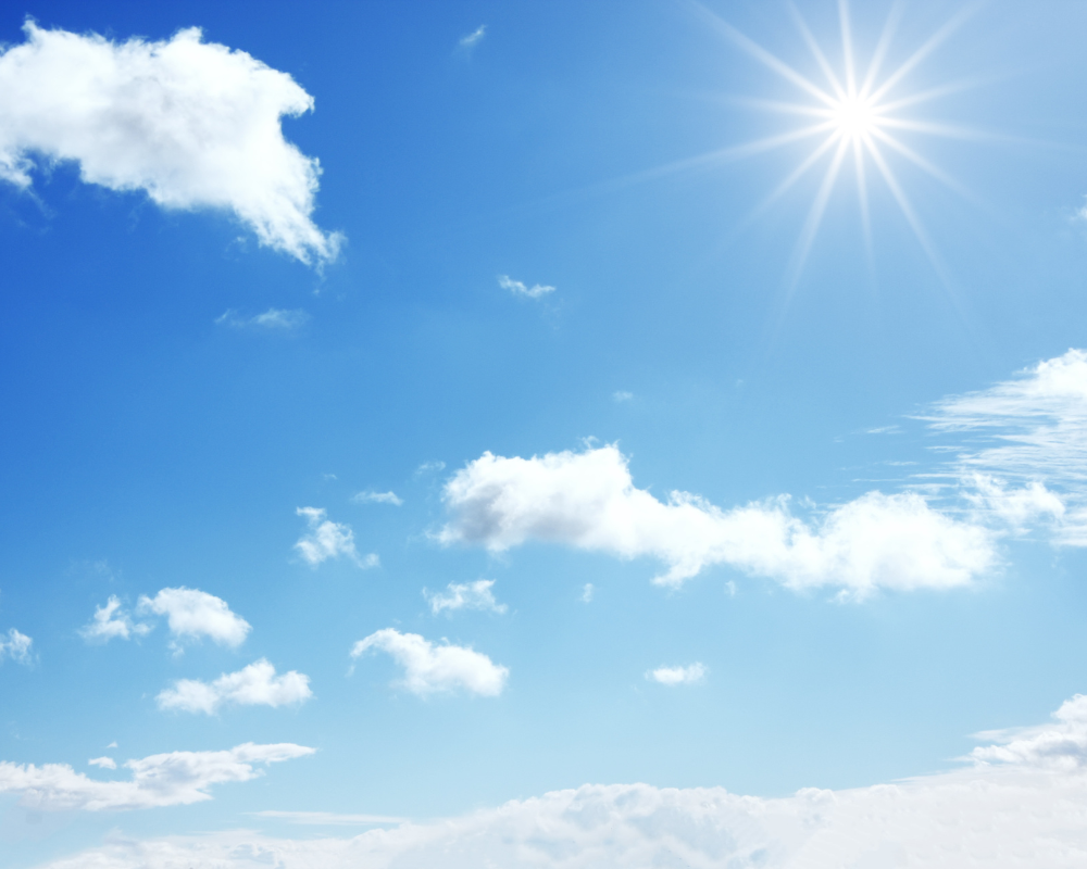 A photo of a blue sky with clouds and sun.