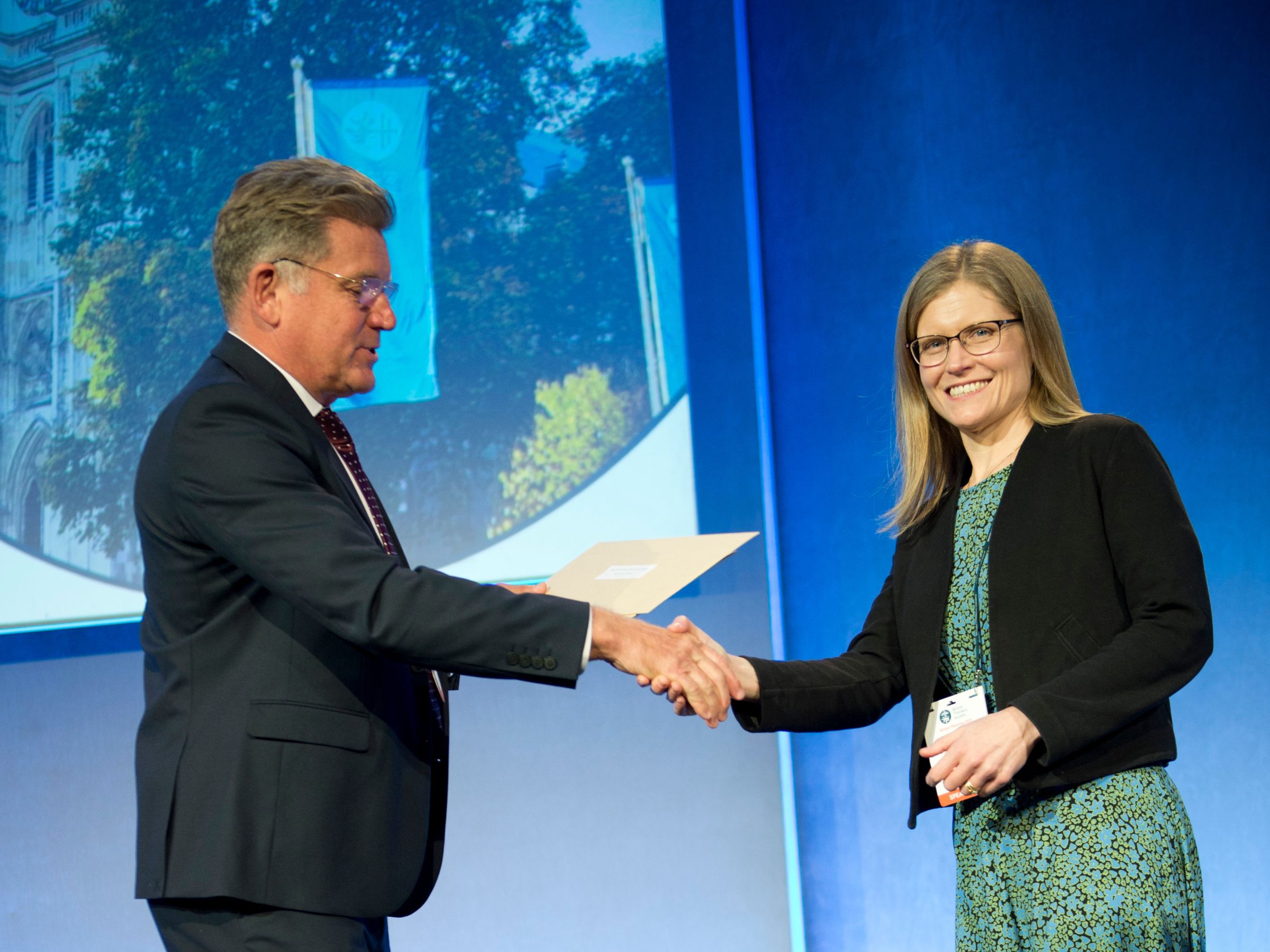 A photo of Jenny Dickens accepting her award.
