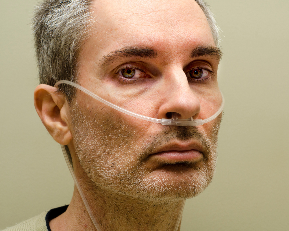 A man with oxygen looking directly at the camera.