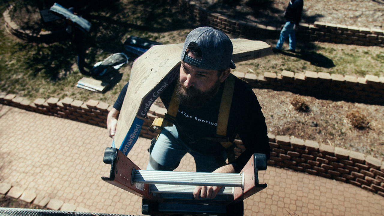 Salazar Roofing - climbing with shingles