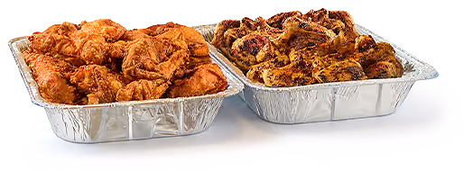 Catering spread in aluminum tins featuring fried and Grilled Chicken.