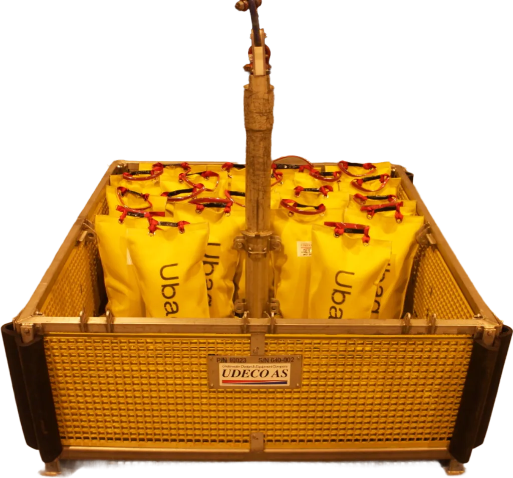 Ubag subsea bags arranged in a Ubas ROV rental basket, featuring yellow bags with "Ubag" branding, designed for subsea deployment and protection against scouring.