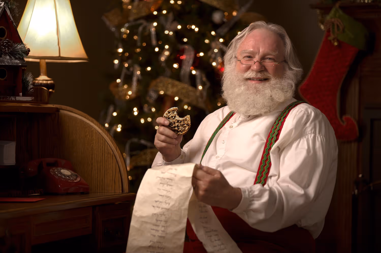 Photo of Santa holding a long paper list