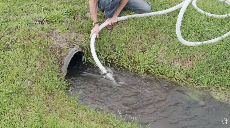 Wranglerstar placing a suction hose in his irrigation ditch to draft water