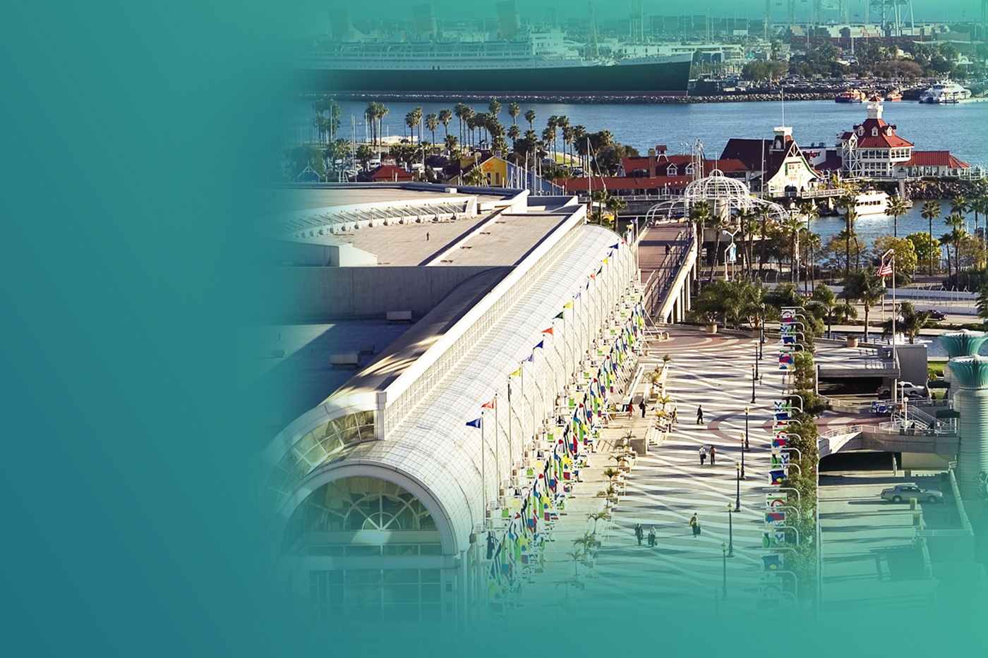 The Long Beach convention center with the ocean, a ship, and palm trees in the background