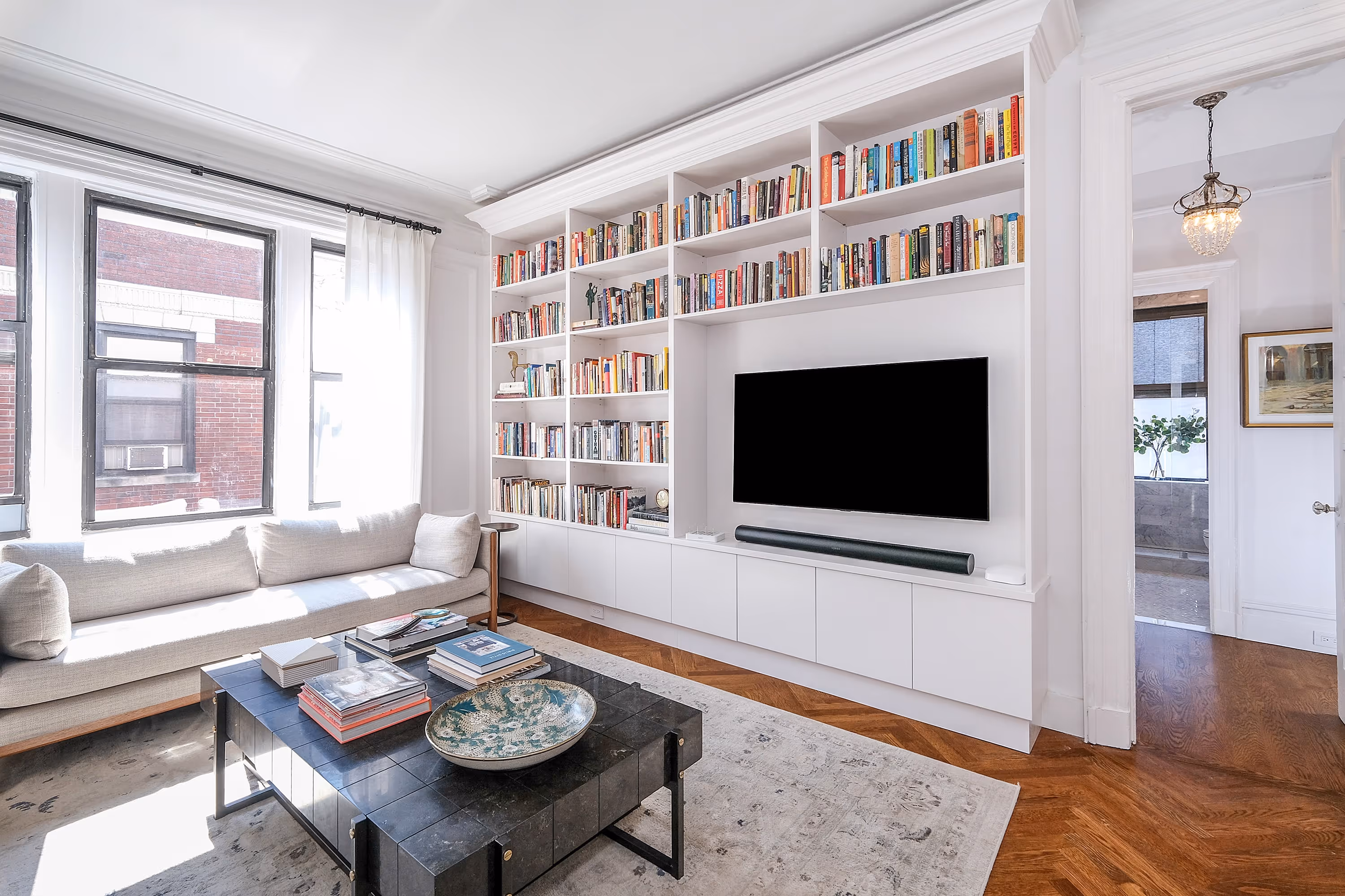 Upper West Side pre-war co-op renovation living room with custom built-in bookshelves at 801 West End Avenue by Gallery KBNY