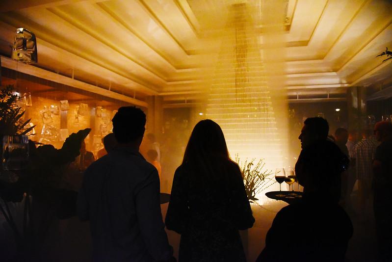 Guests gathered under a softly lit chandelier during an evening event at Jaya House River Park