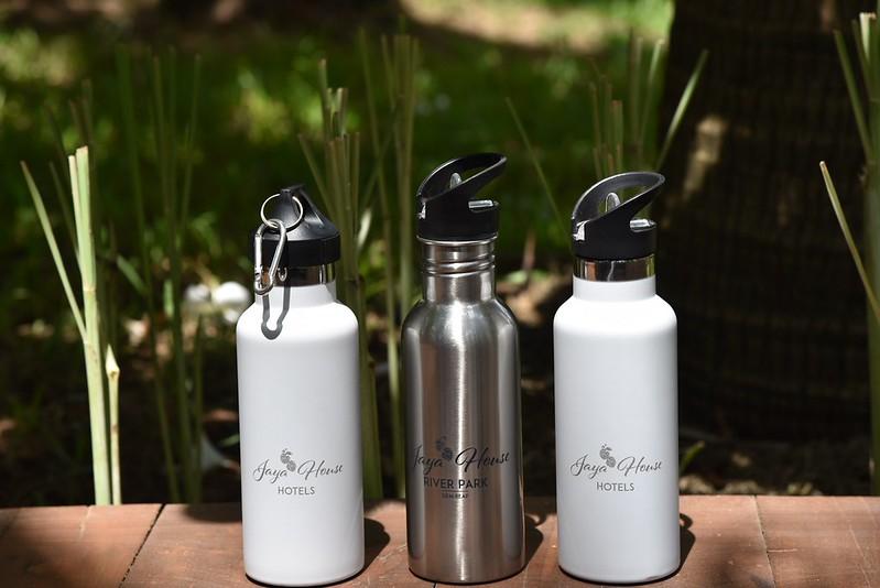 Three reusable Jaya House Hotels water bottles used in place of single-use plastic