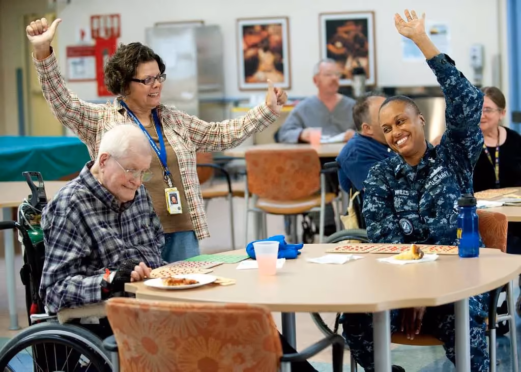 Senior citizens in a senior living center eating and playing games