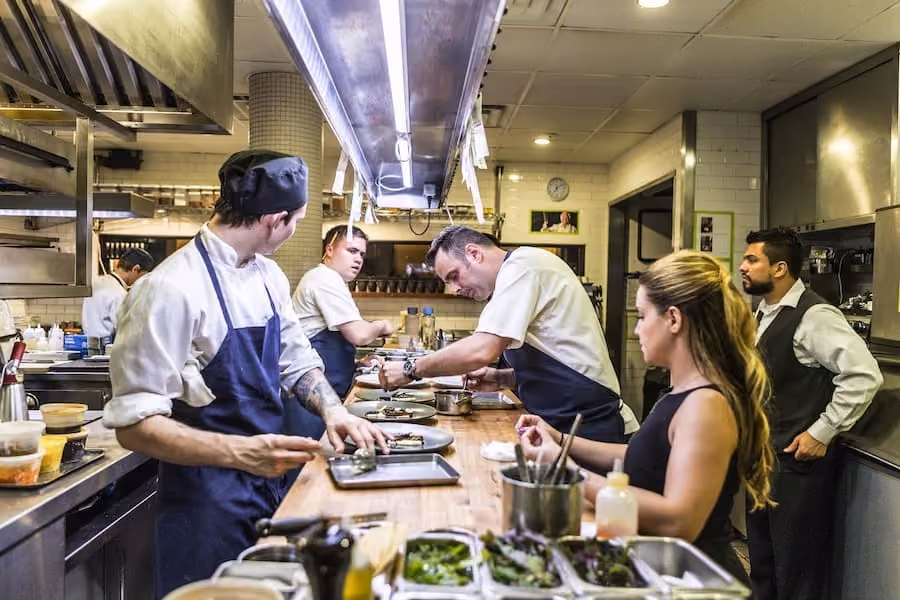 group of people on the kitchen working station