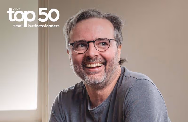 a man smiling with glasses