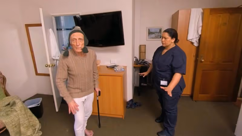 a woman standing next to a man in a room