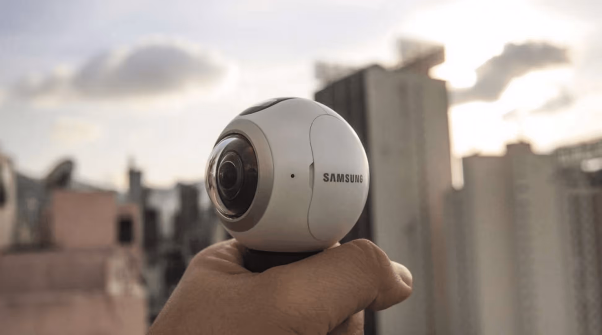a hand holding a camera