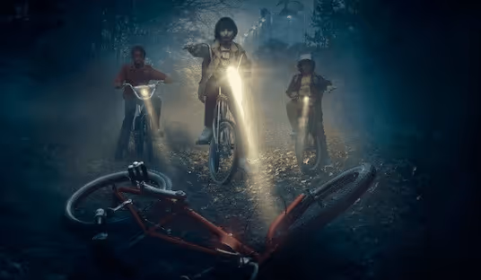 a group of people riding bicycles in the woods