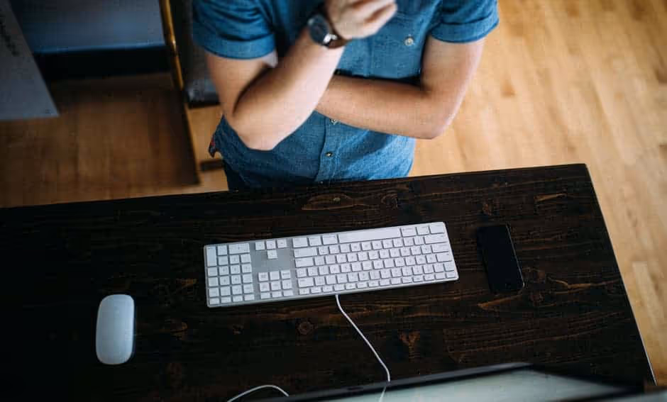 a person sitting at a desk with a keyboard