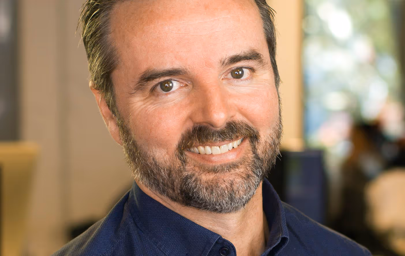 a man with a beard smiling