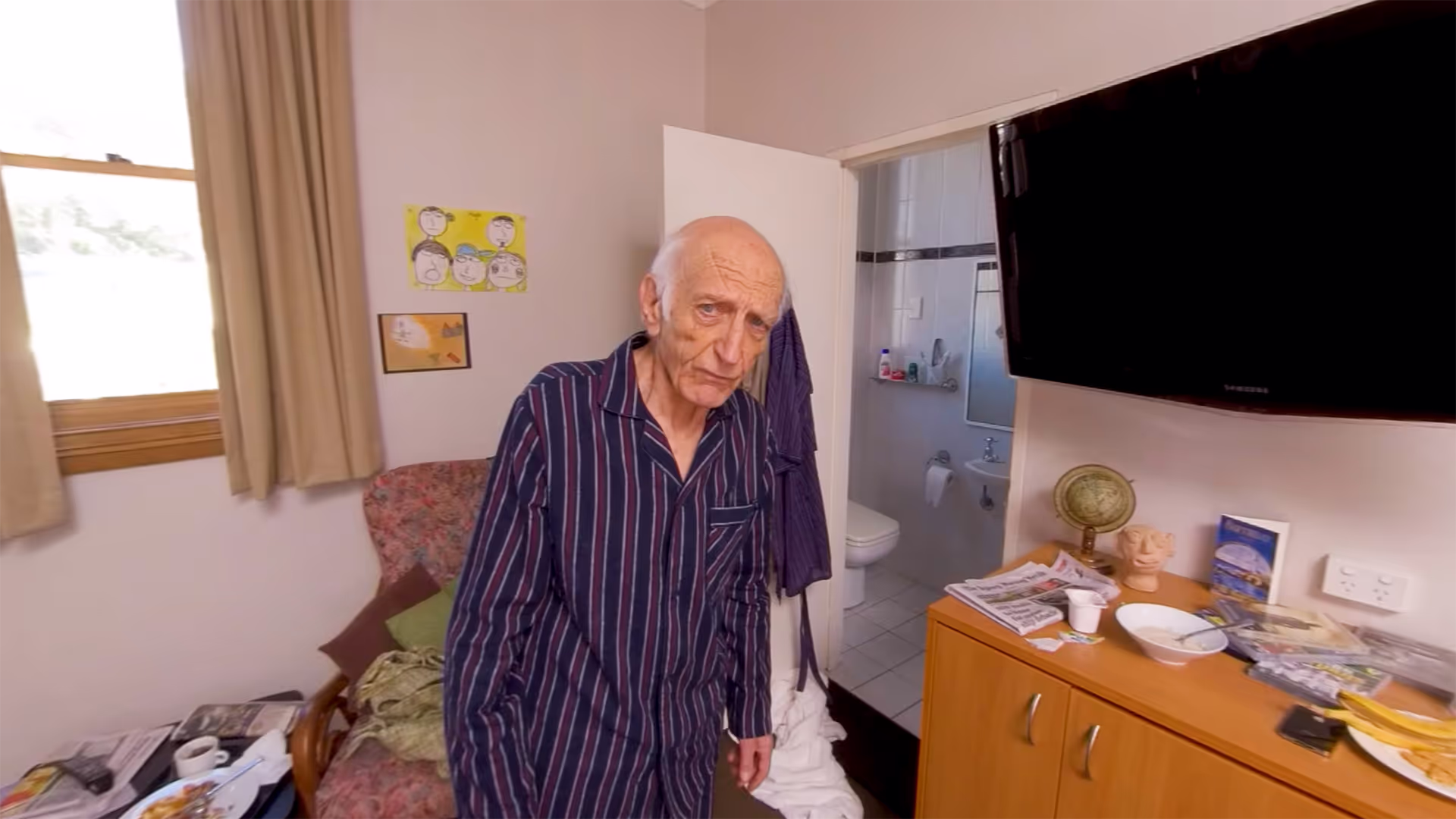 360° view of an elderly man standing in his room looking distressed, illustrating a negative outcome scenario.