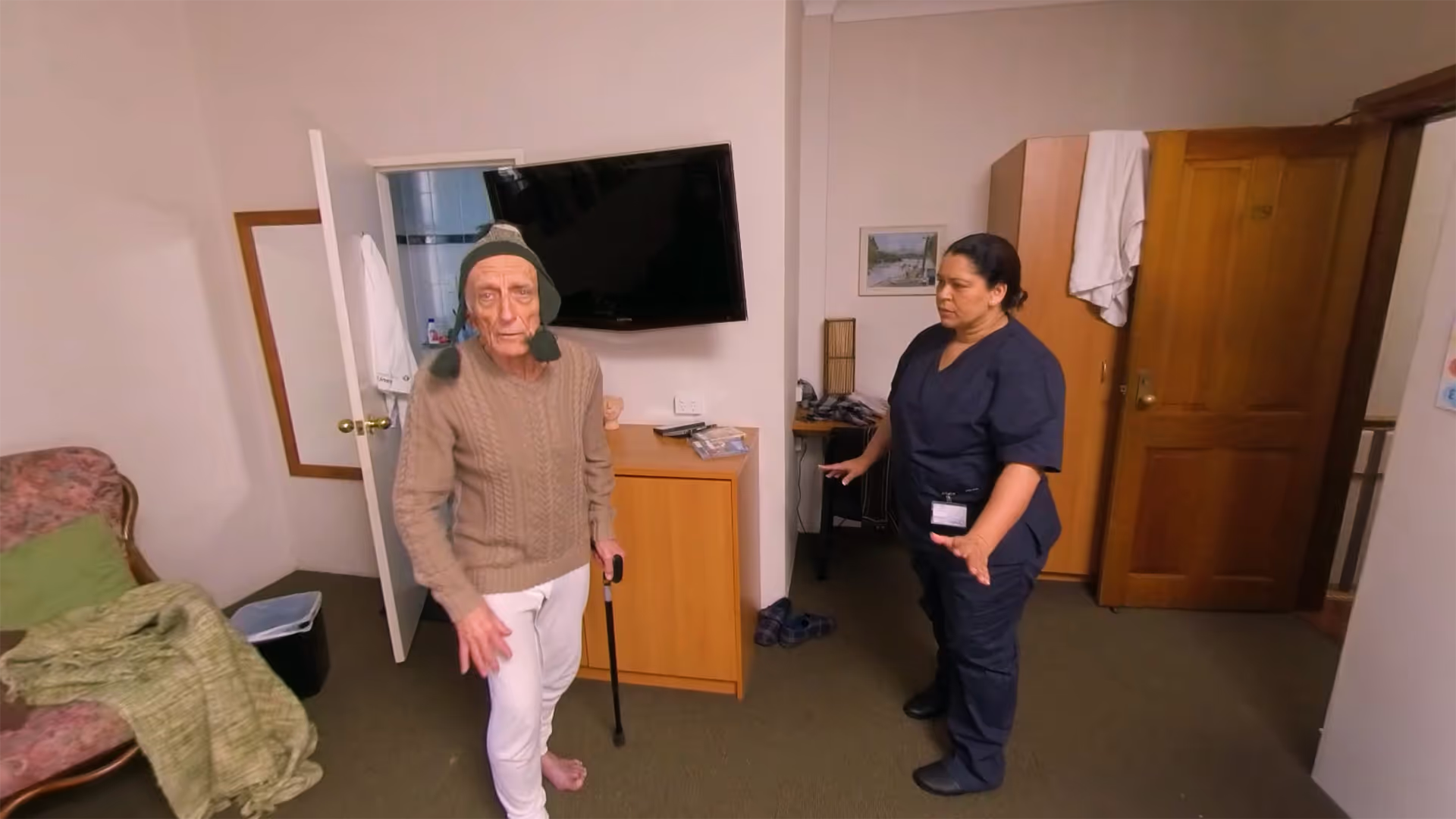 360° VR training scenario showing a nurse caring for an elderly aged care resident with a walking cane in a bedroom
