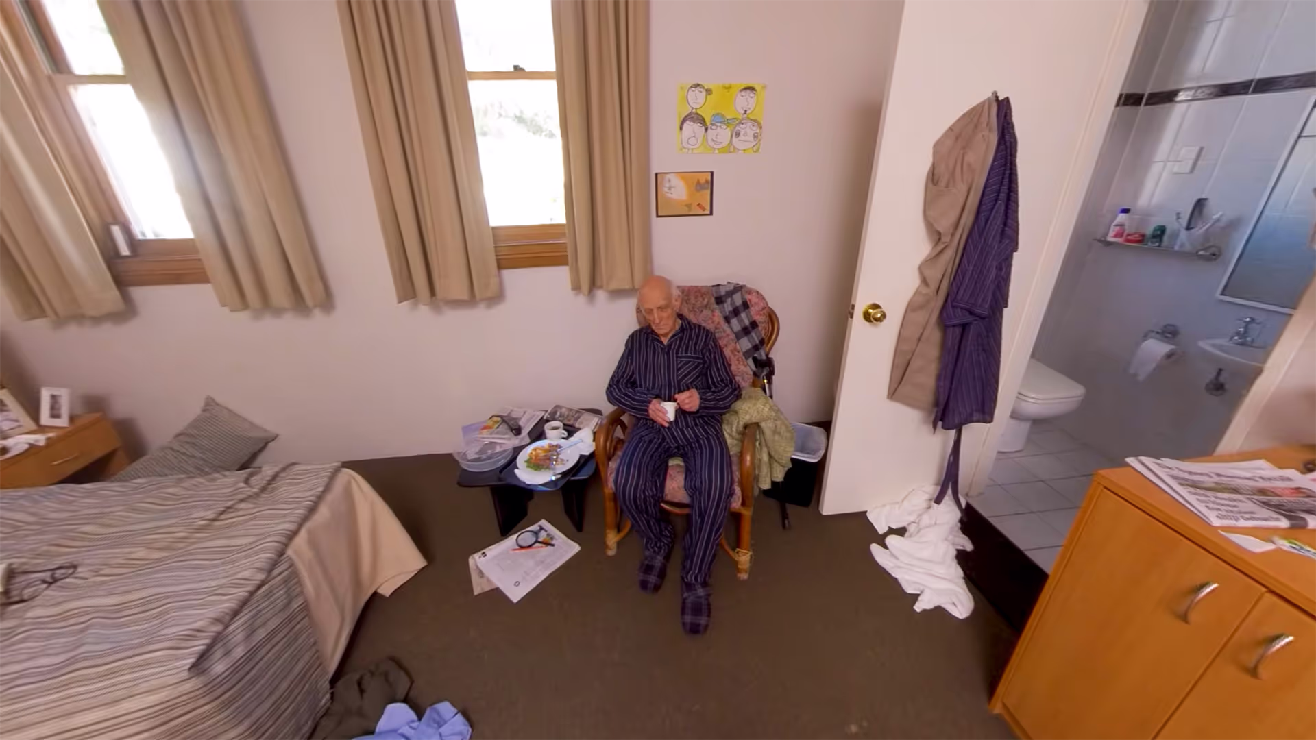 360° view of an elderly man sitting calmly in his room holding a cup of tea, illustrating a positive outcome scenario.