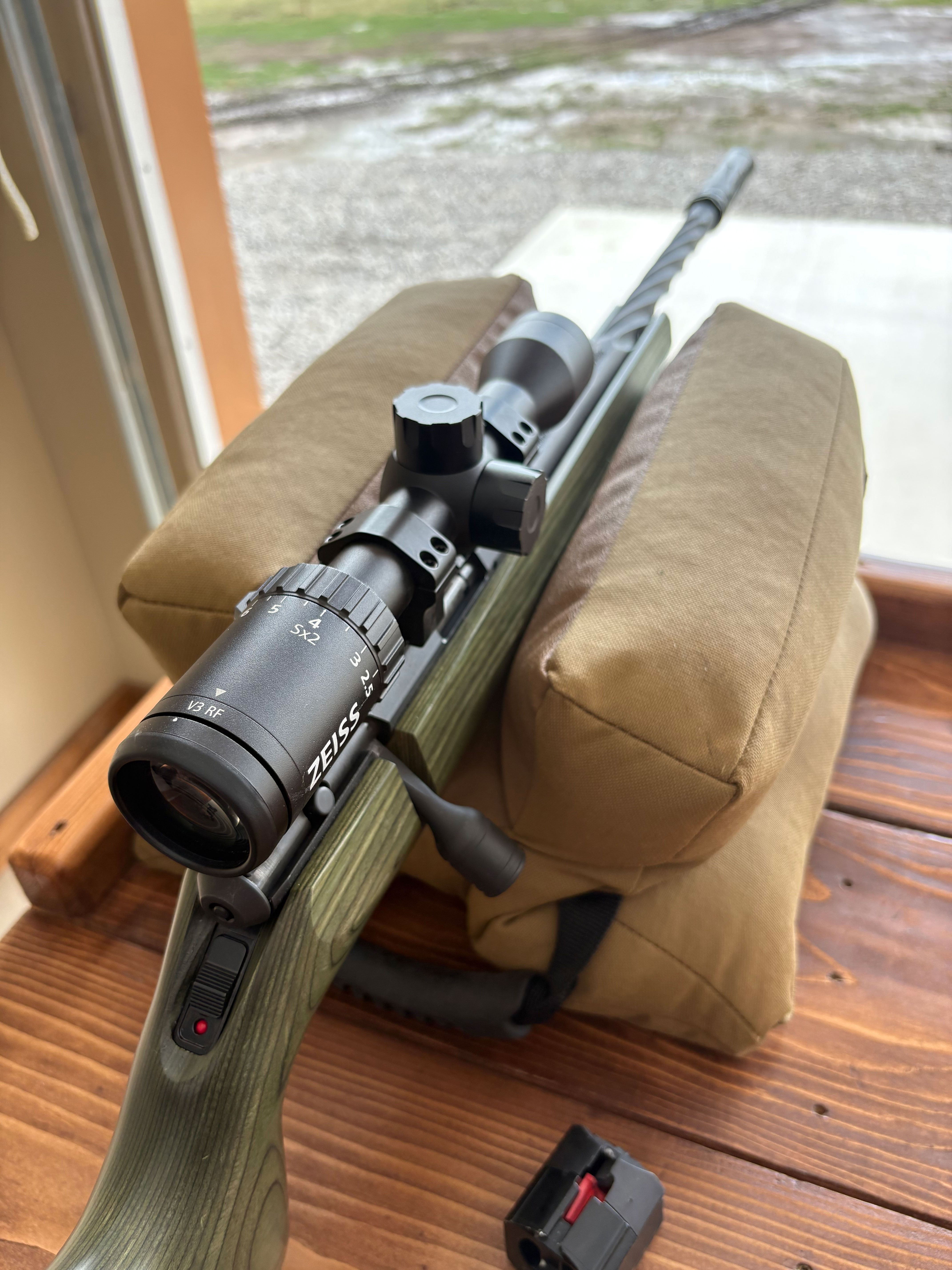 Ruger American rifle fitted with a Zeiss V3 RF riflescope, resting on shooting bags