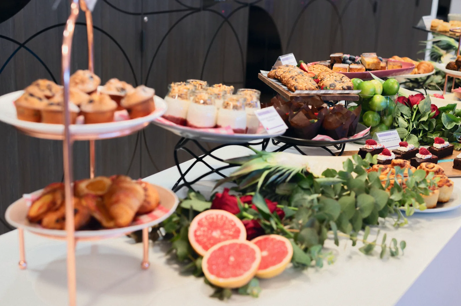 Morning tea spread with pastries, muffins and fresh grapefruit