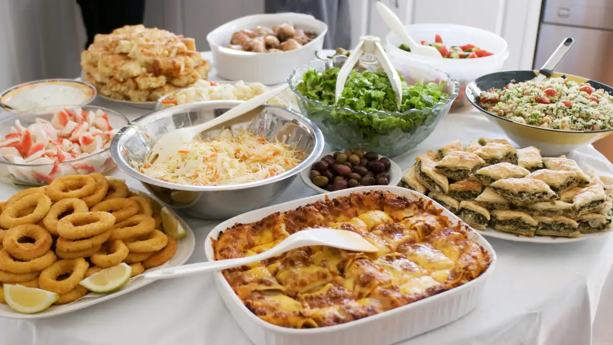 Table with a potluck feast set up.