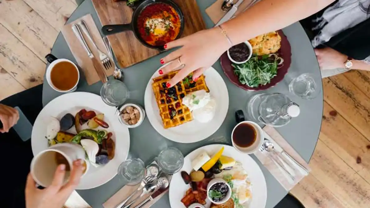 Cafe-style breakfast table with waggles, eggs and coffee.