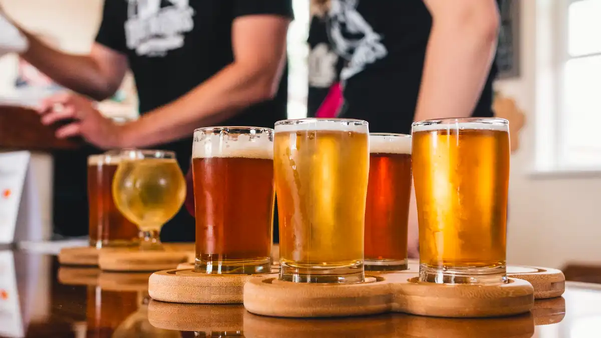 Beer tasting paddles on a bar with various brews.