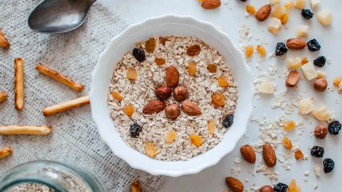 Bowl of oats with dried fruit and nuts.