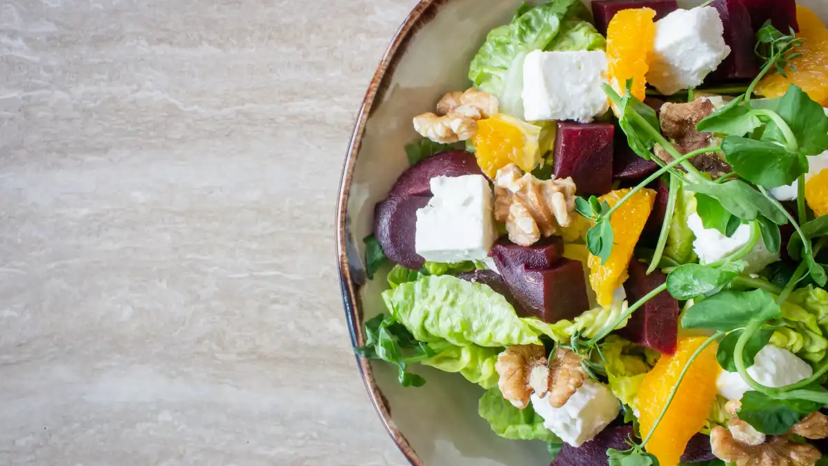 Salad with beetroot, walnuts and feta in a bowl.